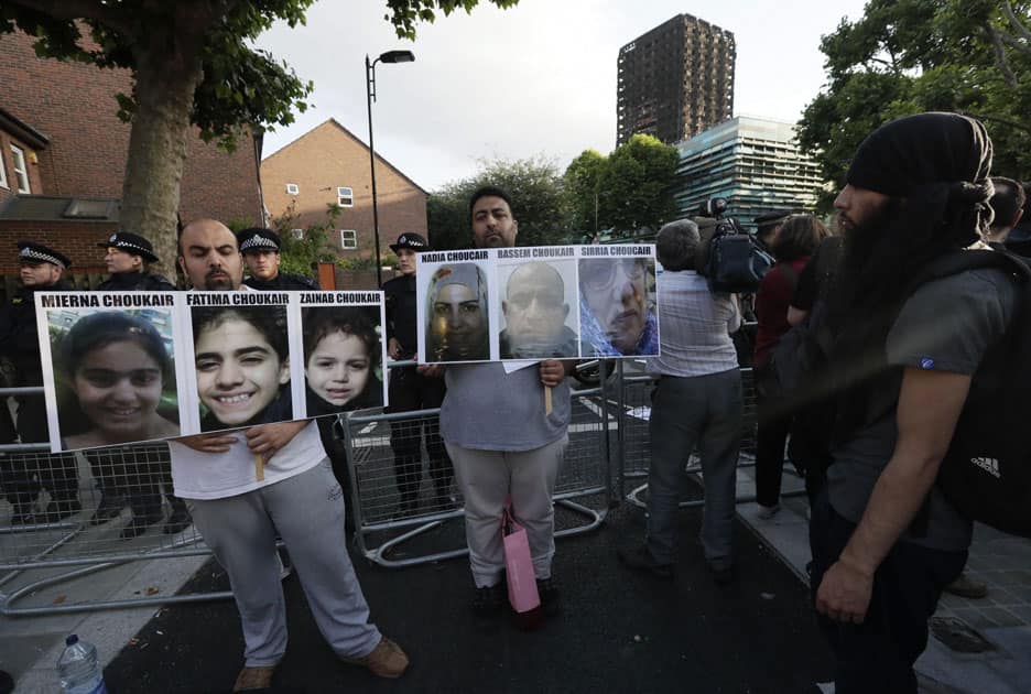 Men display photos of missing family members