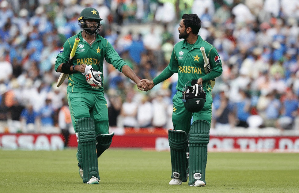 Mohammad Hafeez and teammate Imad Wasim walk from the field