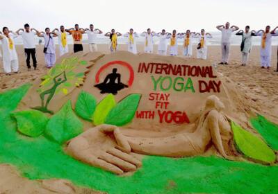 People practice yoga at Puri beach in Odisha