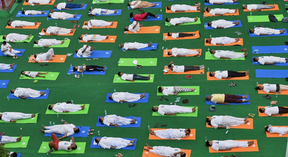 People perform Shavaasan during a yoga session