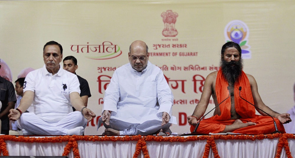 Amit Shah, Gujarat CM Vijay Rupani and Yoga guru Baba Ramdev perform Yoga