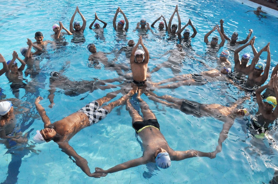 PAC men perform Yoga in a swimming pool