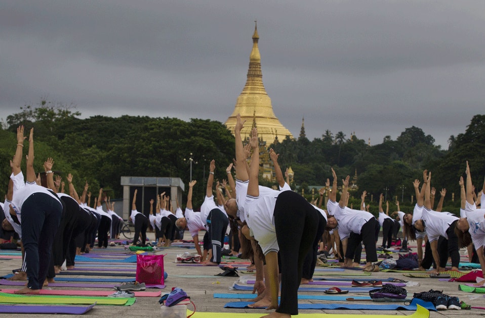 People practice yoga on International Yoga Day