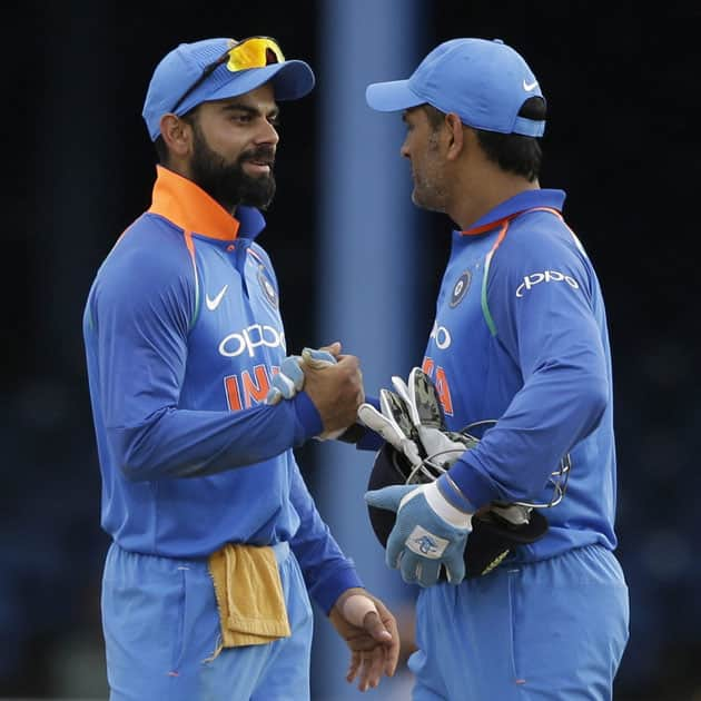 captain Virat Kohli and wicket keeper MS Dhoni shake hands