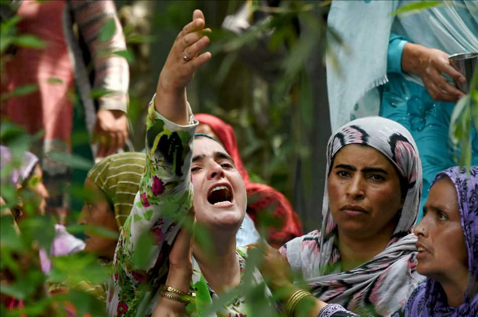 A woman crying during the funeral procession of a civilian