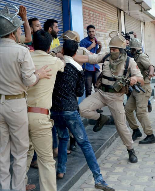 Shopkeepers scuffle with policemen during the violent clashes