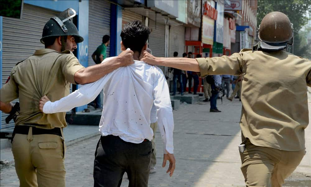 Police arrest a student during clashes