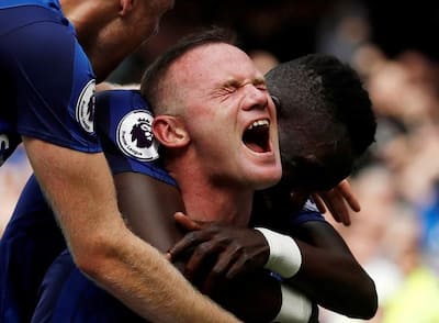 Everton's Wayne Rooney celebrates with teammates