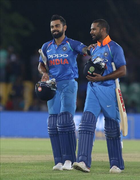 Virat Kohli and Shikhar Dhawan leave the field after winning the first ODI