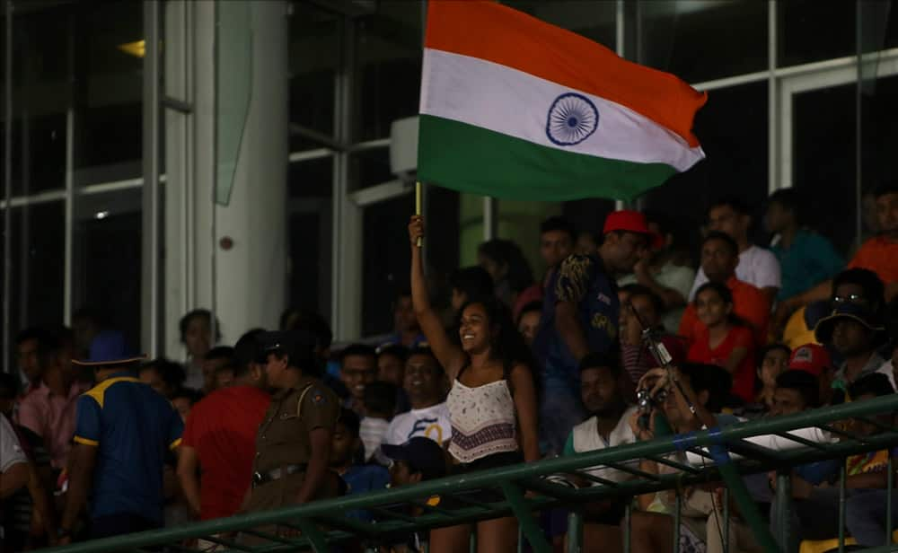 Fans cheer during the first ODI cricket match