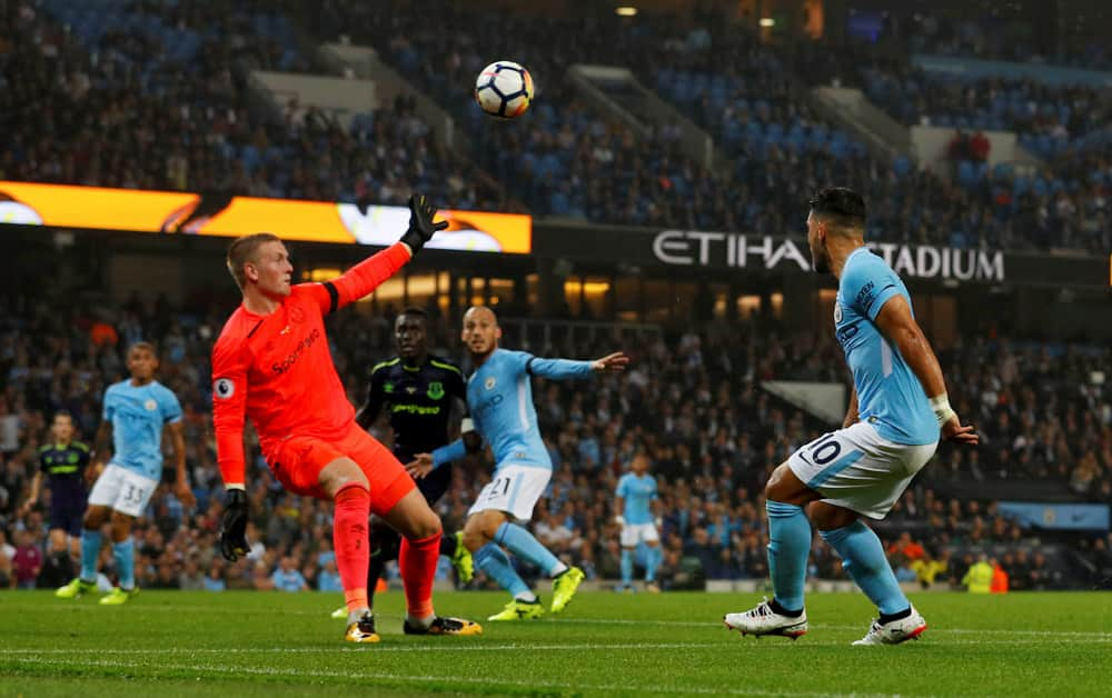 Everton's Jordon Pickford tries to prevent Manchester City's Sergio Aguero from scoring