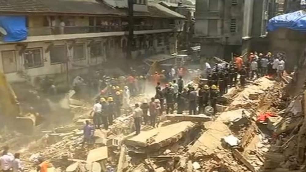 People and rescue personnel are seen after a building collapsed People and rescue personnel are seen after a building collapsed