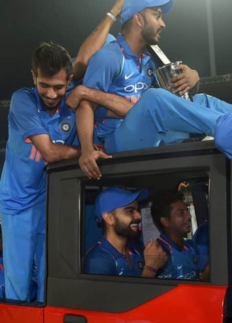 India's captain Virat Kohli, takes a ride in a vehicle with fellow team members