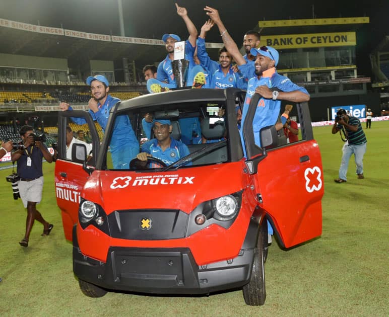 India's Mahendra Singh Dhoni drive a vehicle with Members of Indian cricket team after their win over Sri Lanka during the fifth ODI match in Colombo, Sri Lanka.