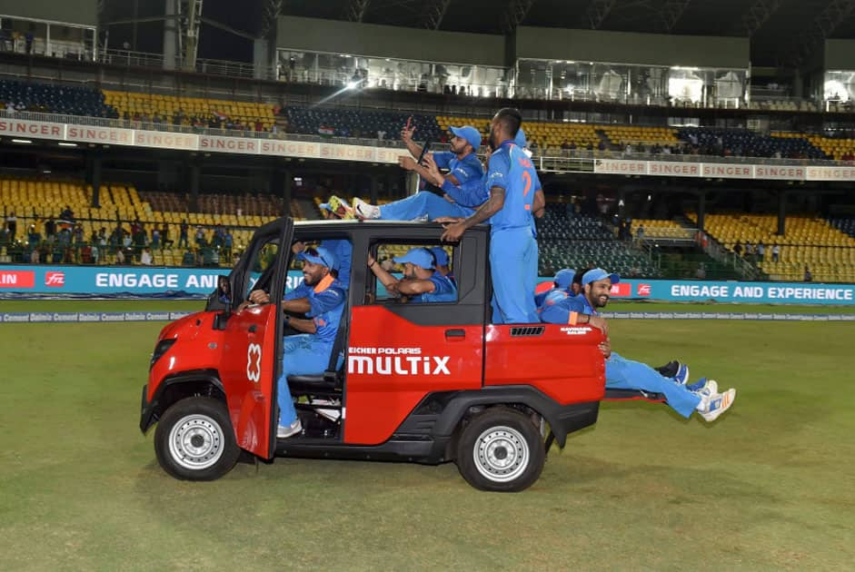 India's Mahendra Singh Dhoni drive a vehicle