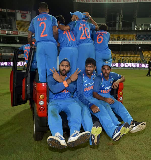 Members of Indian cricket team celebrates with a vehicle