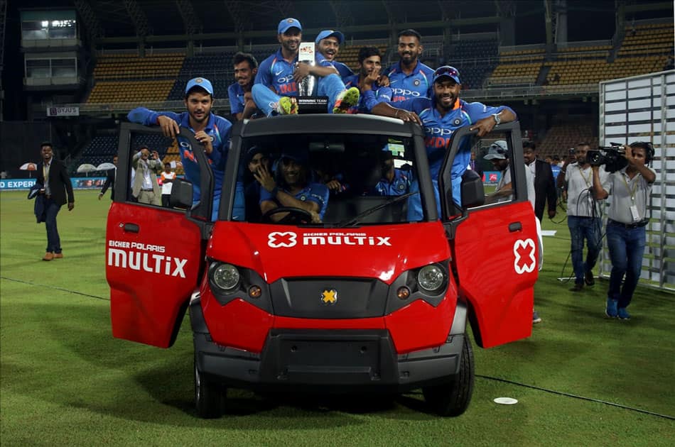 Indian cricket team enjoying a ride on a vehicle