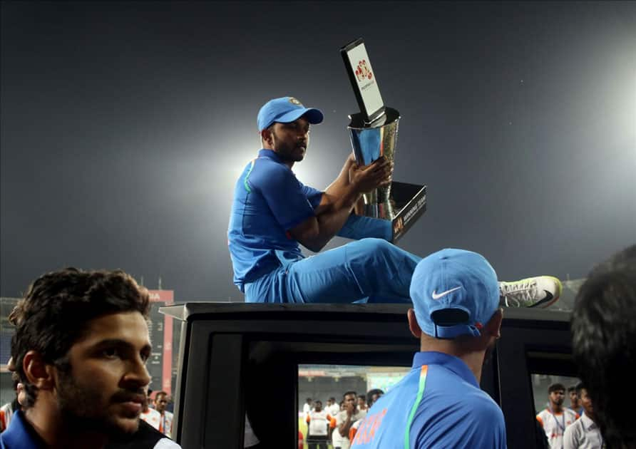 Indian cricket team enjoying a ride on a vehicle after winning