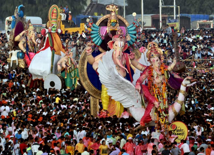 People carry Ganesh idol for immersion at Girgoan Chawpaty