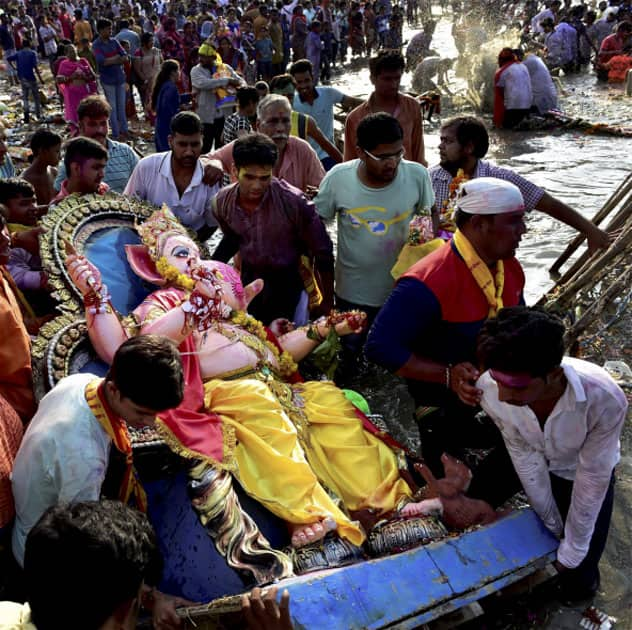 Devotees carry an idol of Lord Ganesha to immerse