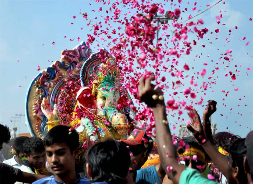 Devotees carry an idol of Lord Ganesha to immerse it into the Yamuna River