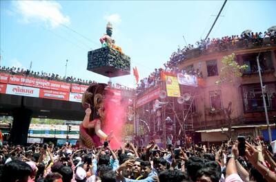 Devotees gather as a Ganesh idol is being taken for immersion