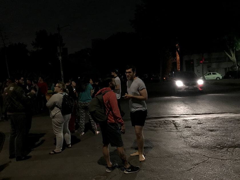 People gather on a street after an earthquake hit Mexico City