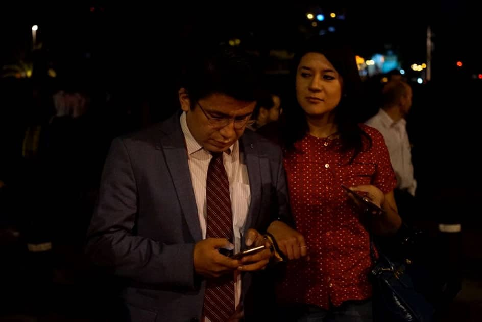 People react on a street after an earthquake jolted Mexico City, capital of Mexico