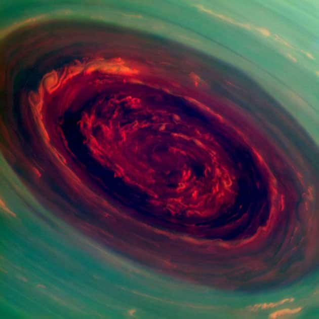 The spinning vortex of Saturn's north polar storm resembles a deep red rose of giant proportions surrounded by green foliage in this false-color imageThe spinning vortex of Saturn's north polar storm resembles a deep red rose of giant proportions surrounded by green foliage in this false-color image