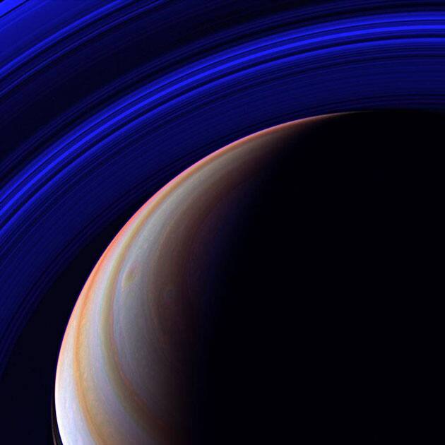 The Cassini spacecraft surveys Saturn's outstretched ring system in the infrared from a vantage point high above the planet's northern latitudes