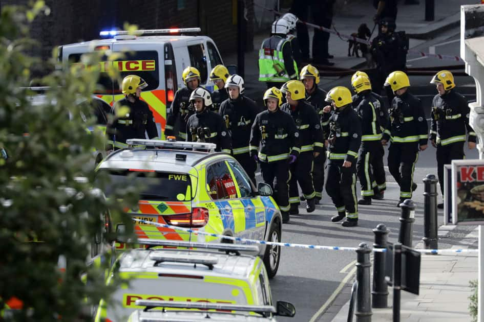 Members of the emergency services work near Parsons Green tube station in London