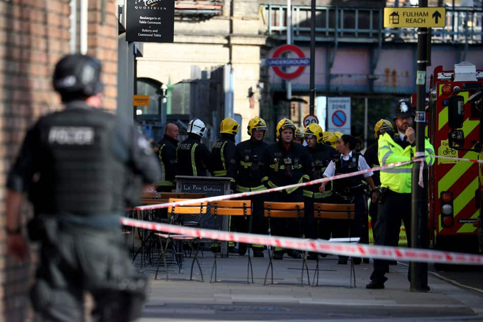 Members of the London Fire Brigade stand by cordon near Parsons Green tube station in London