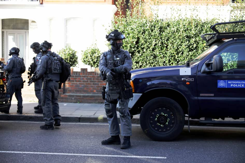 Armed policemen stand by cordon outside Parsons Green tube station in London, Britain