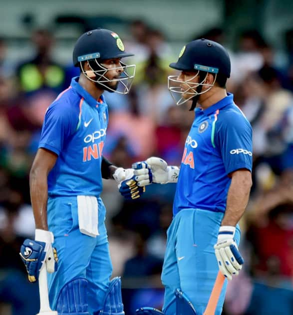 M S Dhoni greets Hardik Pandya after scoring his half century during the first India-Australia ODI cricket match