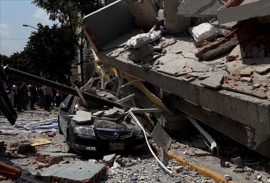 vehicle crushed by debris from a collapsed building after an earthquake in Mexico City, capital of Mexico