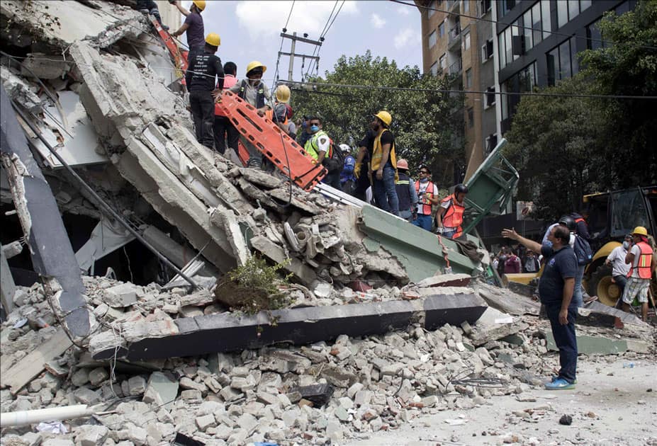 People work on a collapsed building after an earthquake in Mexico City, capital of Mexico