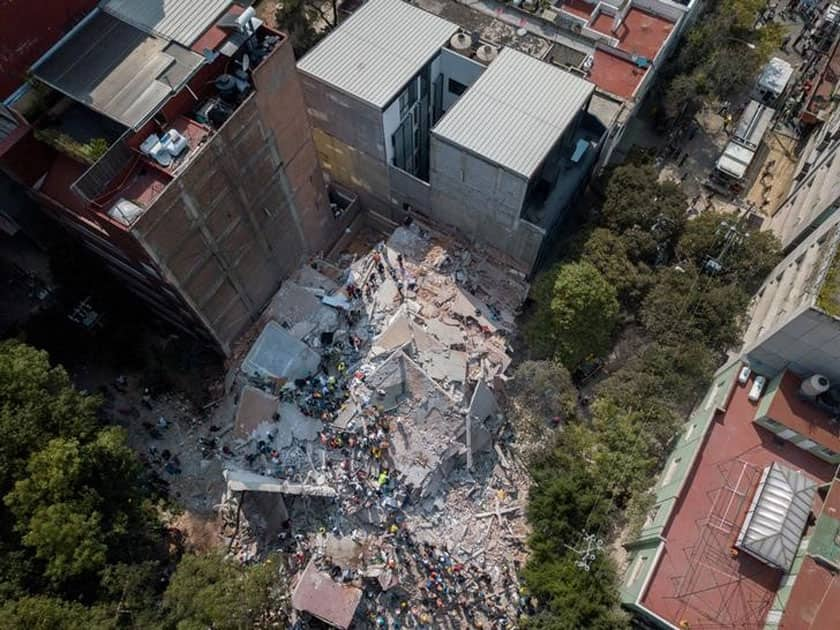 Search and rescue operations are carried out at the site of a collapsed building after an earthquake in Condesa, Mexico City