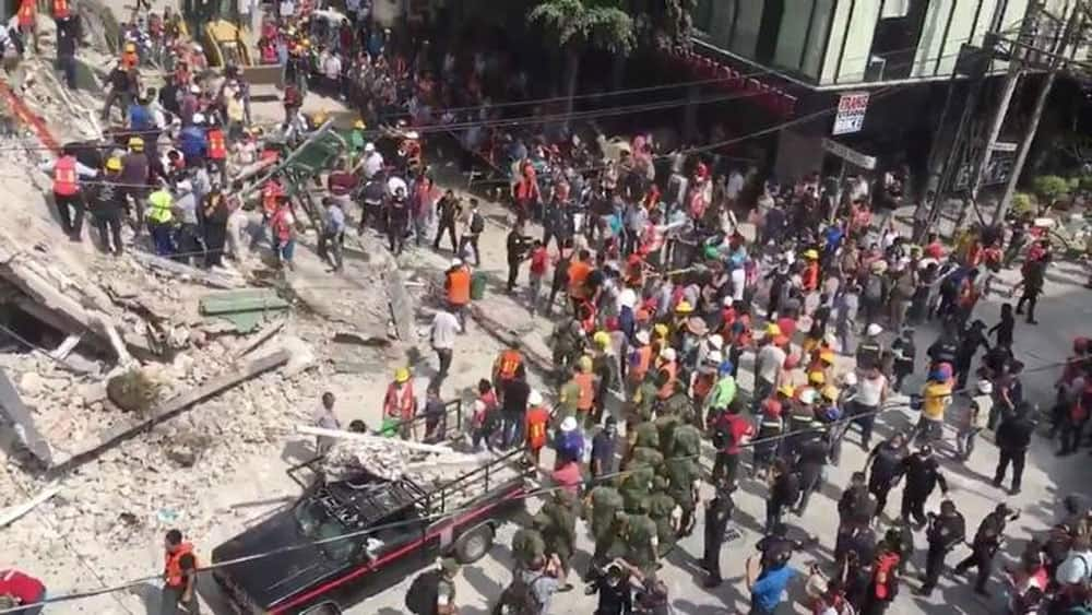 Search and rescue operations are carried out at the site of a collapsed building after an earthquake in Roma Norte, Mexico City