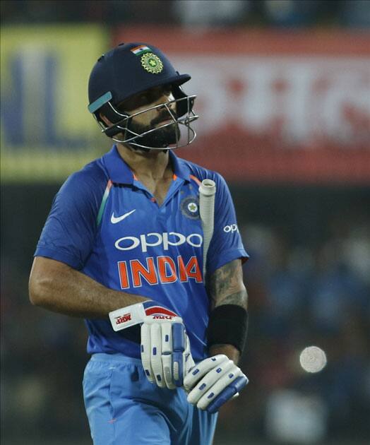 Indian skipper Virat Kohli walks back to the pavilion after getting dismissed during the third ODI cricket match between India and Australia at Holkar Cricket Stadium in Indore