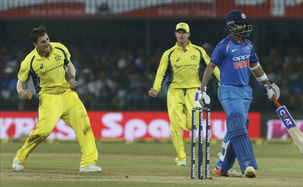 Australia's Pat Cummins celebrates fall of Ajinkya Rahane's wicket during the third ODI cricket match between India and Australia at Holkar Cricket Stadium in Indore