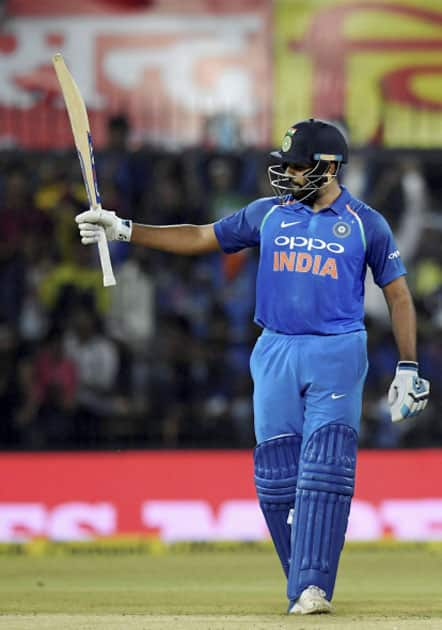 India's Rohit Sharma celebrates his half-century during the 3rd ODI cricket match against Australia at Holkar Stadium in Indore.