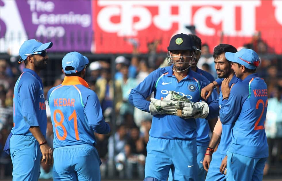 India's cricketers celebrate fall of a wicket during the third ODI cricket match between India and Australia at Holkar Cricket Stadium in Indore