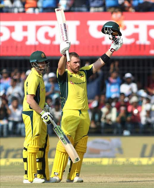 Australian cricketer Aaron Finch celebrates his century during the third ODI cricket match between India and Australia at Holkar Cricket Stadium in Indore