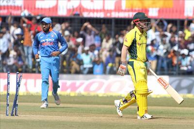 Australian cricketer David Warner walks back to the pavilion after getting dismissed during the third ODI cricket match between India and Australia at Holkar Cricket Stadium in Indore