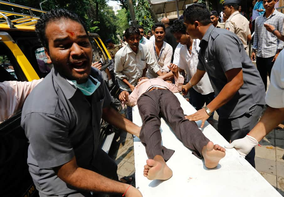 A stampede victim is carried on a stretcher at a hospital in Mumbai.