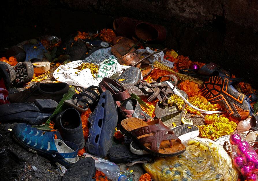 Footwear of the victims of a stampede are seen below a railway station's pedestrian overbridge in Mumbai.