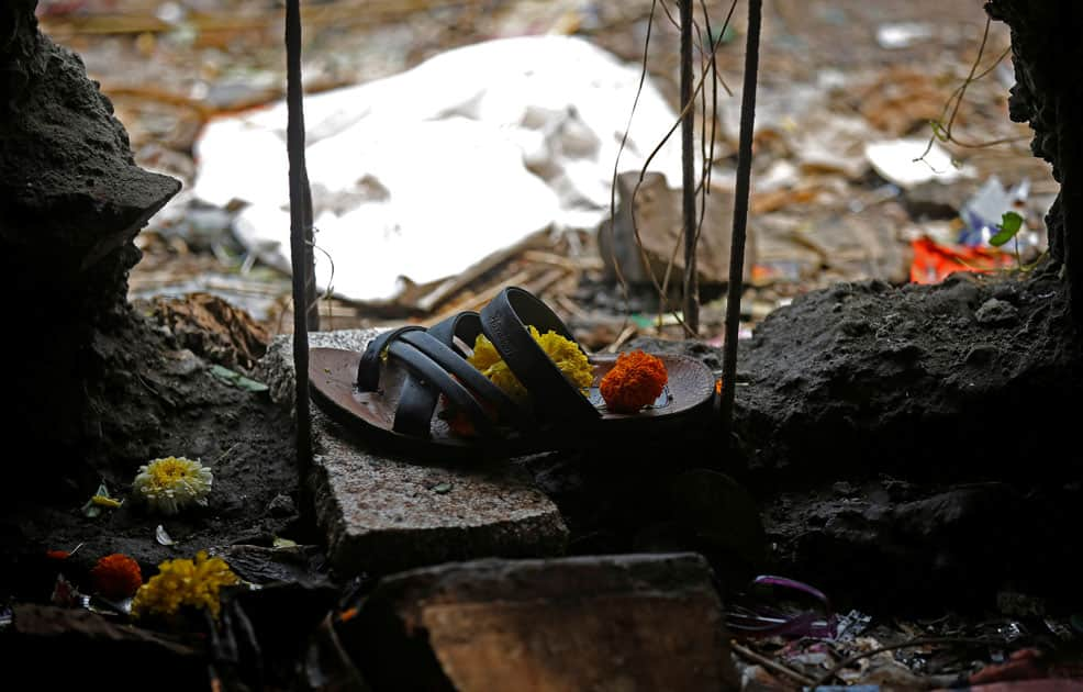 A sandle of one of the victims of a stampede is seen below a railway station's pedestrian overbridge in Mumbai.