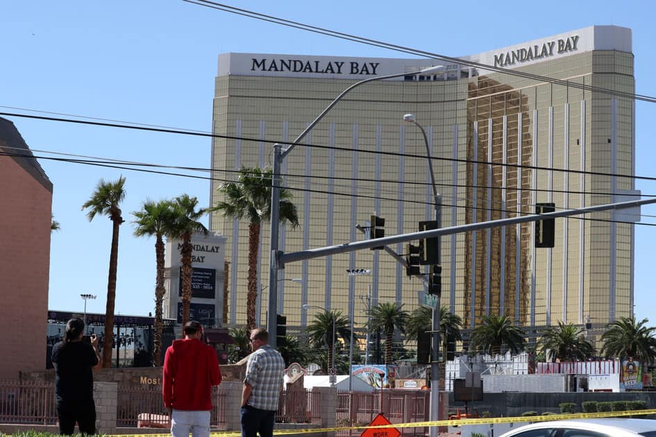 People look at the site of the Route 91 music festival mass shooting outside the Mandalay Bay Resort and Casino in Las Vegas.