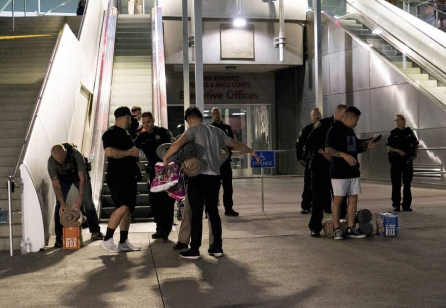 Metro Police conduct a search on people bringing supplies to the people taking refuge inside the Thomas & Mack following a mass shooting at the Route 91 music festival in Las Vegas.