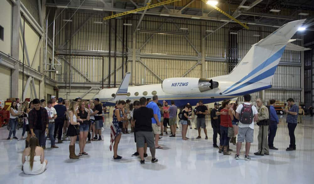 Police arrive at the scene to escort people to safety after hiding inside the Sands Corporation plane hangar after a mass shooting in which dozens were killed at the Route 91 Harvest Festival in Las Vegas.